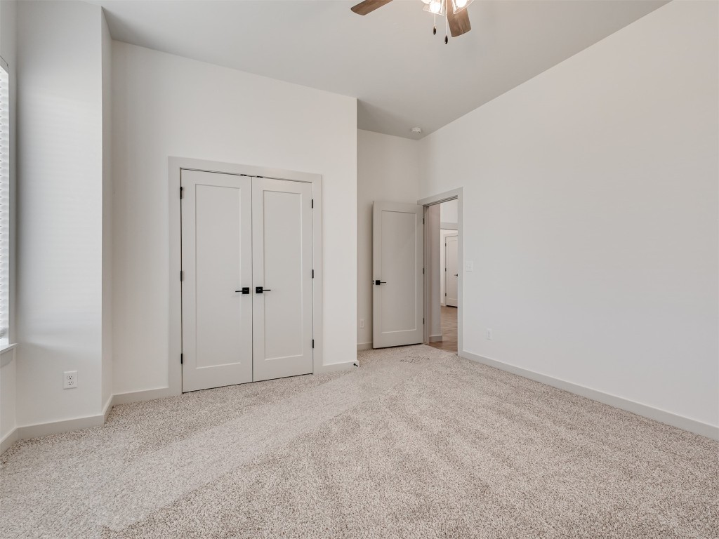 508 Venetian Avenue, Piedmont, OK 73078 unfurnished bedroom with light colored carpet and ceiling fan