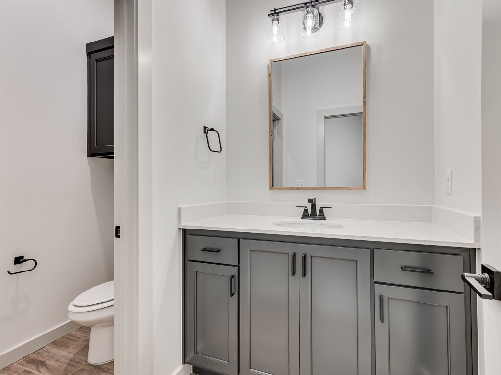 508 Venetian Avenue, Piedmont, OK 73078 bathroom featuring wood-type flooring, vanity, and toilet