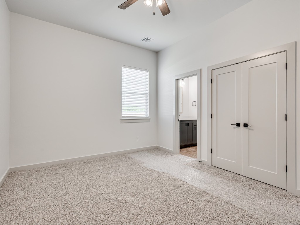 508 Venetian Avenue, Piedmont, OK 73078 unfurnished bedroom featuring light carpet, a closet, and ceiling fan