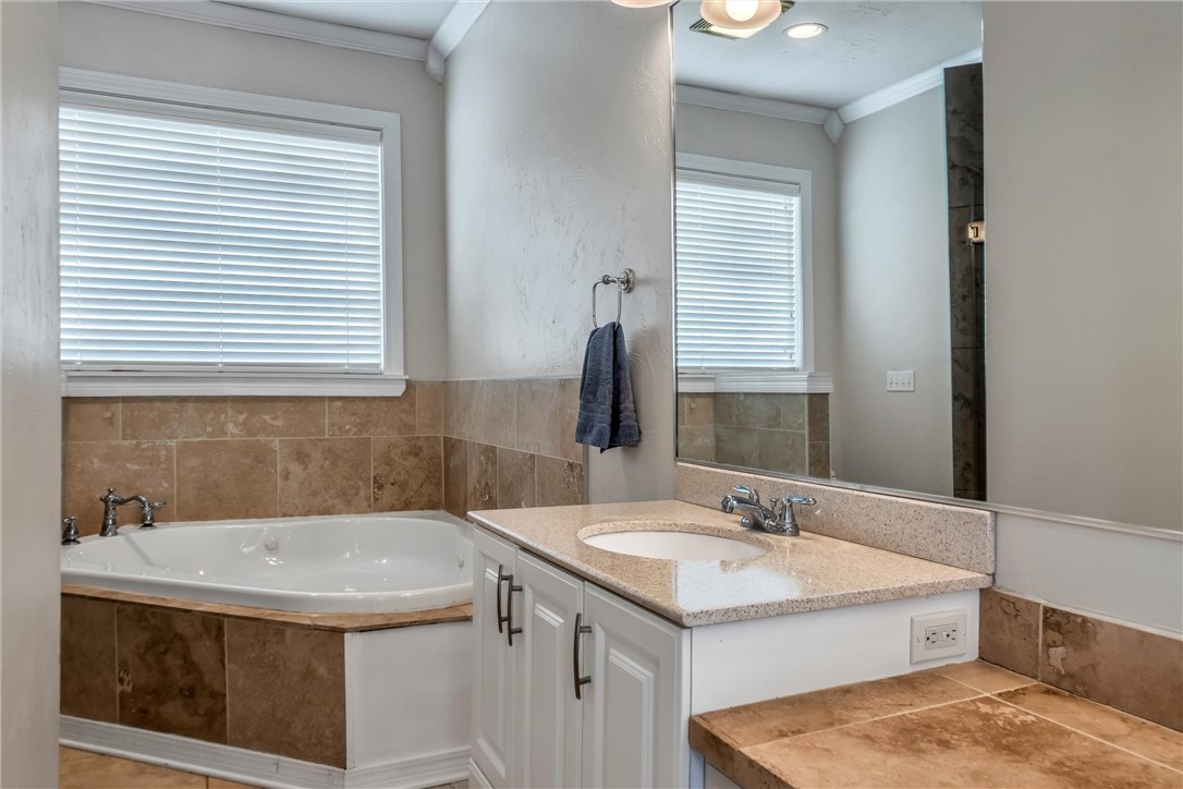 1117 Tedford Way, Nichols Hills, OK 73116 bathroom with ornamental molding, a bathtub, oversized vanity, and tile flooring