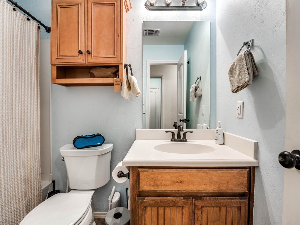 1113 SW 155th Street, Oklahoma City, OK 73170 full bathroom featuring shower / bathtub combination with curtain, toilet, and vanity
