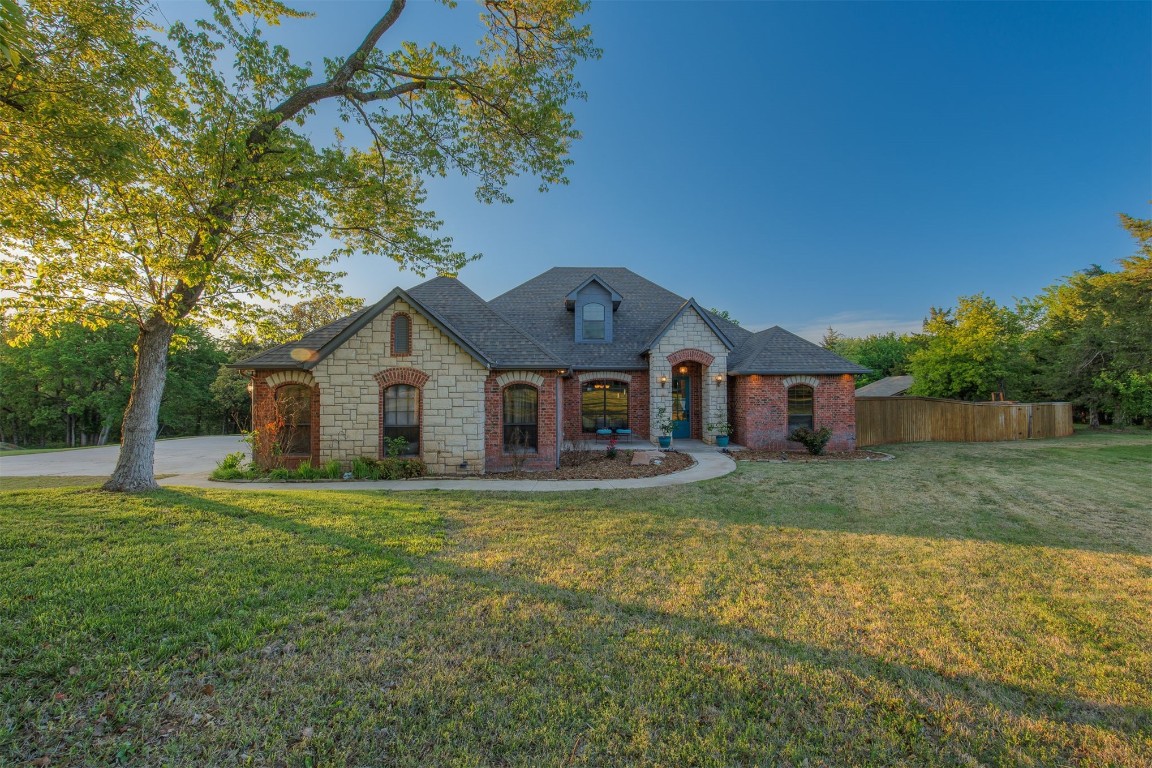 Located in the highly desirable Edmond School District, this remarkable home sits nestled on a 3.23 acre wooded cul-de-sac lot with just under 3,500 square feet of luxury and amenities that are unparalleled. The inviting main floor is flooded with natural light and features vaulted ceilings, a wood burning fireplace that serves as the focal point for the living area, a true study, real hardwood floors and a formal dining room perfect for hosting. Upstairs you will find a large bonus room that could serve as a 5th bedroom if preferred. The kitchen has plenty of storage and counter space for meal preparation and is complete with stainless steel appliances including a double oven. The adjacent breakfast area opens to a gorgeous outdoor patio surrounded by lush landscaping - the perfect backdrop for morning coffee or unwinding as you soak in Oklahoma sunsets amidst the neighborhood's deer and wildlife. This backyard oasis includes a HUGE custom outdoor kitchen w/ pergola and plenty of bar seating as well as a concrete area for al fresco dining or a game of horseshoes or cornhole. THE perfect spot for entertaining. ALL Bull outdoor appliances. Braham 39in grill with insulated jacket. 1,000 gallon propane tank buried in front yard that runs the cooking appliances in outdoor kitchen-also heats pool and hot tub. Extra land is just waiting for a shop for all the toys! This home literally has it all! Schedule your private tour today and experience the beauty and comfort of this magnificent property. It's the dream home you've been waiting for and just in time for summer too!