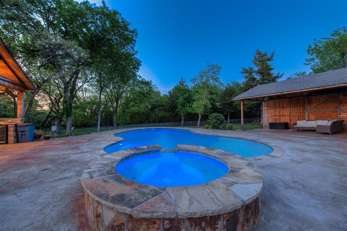 10901 Hunters Pointe, Edmond, OK 73034 view of swimming pool with a patio area and an in ground hot tub