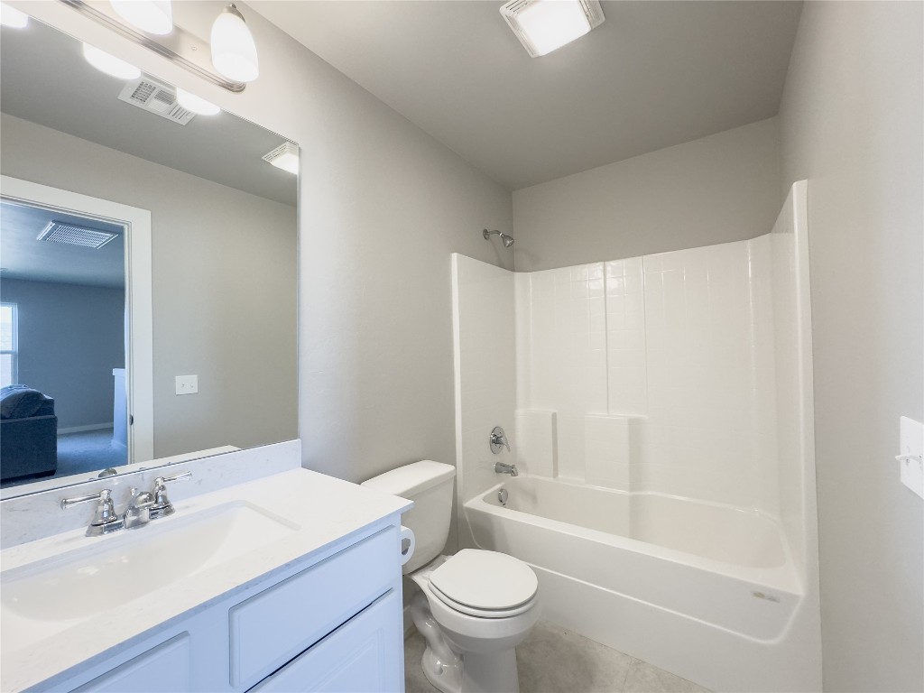 5591 Grassland Drive, Guthrie, OK 73044 full bathroom featuring tile floors, toilet, oversized vanity, and bathing tub / shower combination