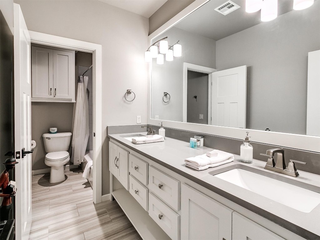 89 Ridgeline Road, Carlton Landing, OK 74432 bathroom with double vanity, toilet, and tile floors