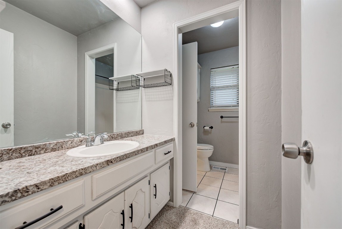 7728 Northgate Avenue, Oklahoma City, OK 73162 bathroom with vanity, tile floors, and toilet
