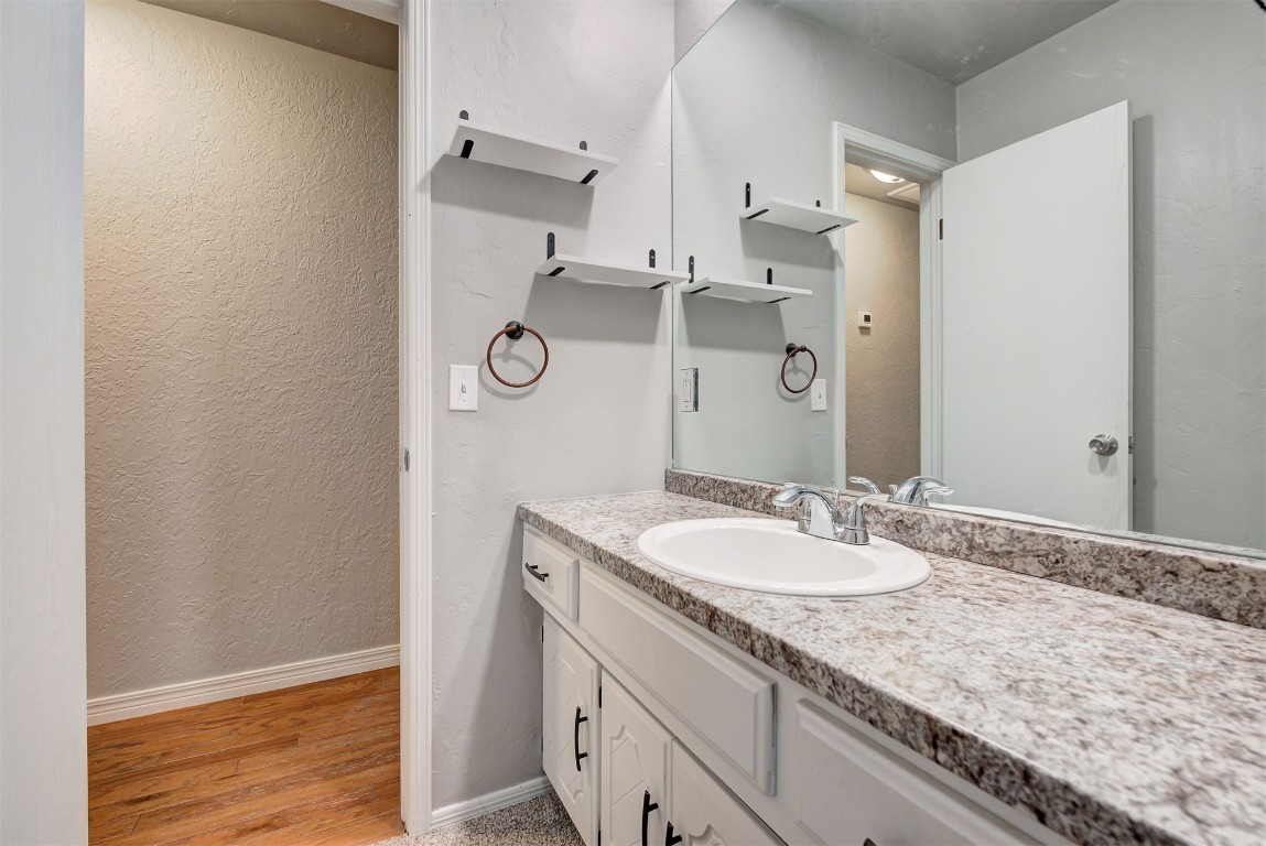 7728 Northgate Avenue, Oklahoma City, OK 73162 bathroom with oversized vanity and hardwood / wood-style flooring