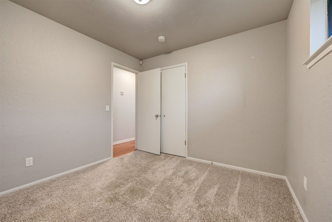 7728 Northgate Avenue, Oklahoma City, OK 73162 unfurnished bedroom featuring light carpet
