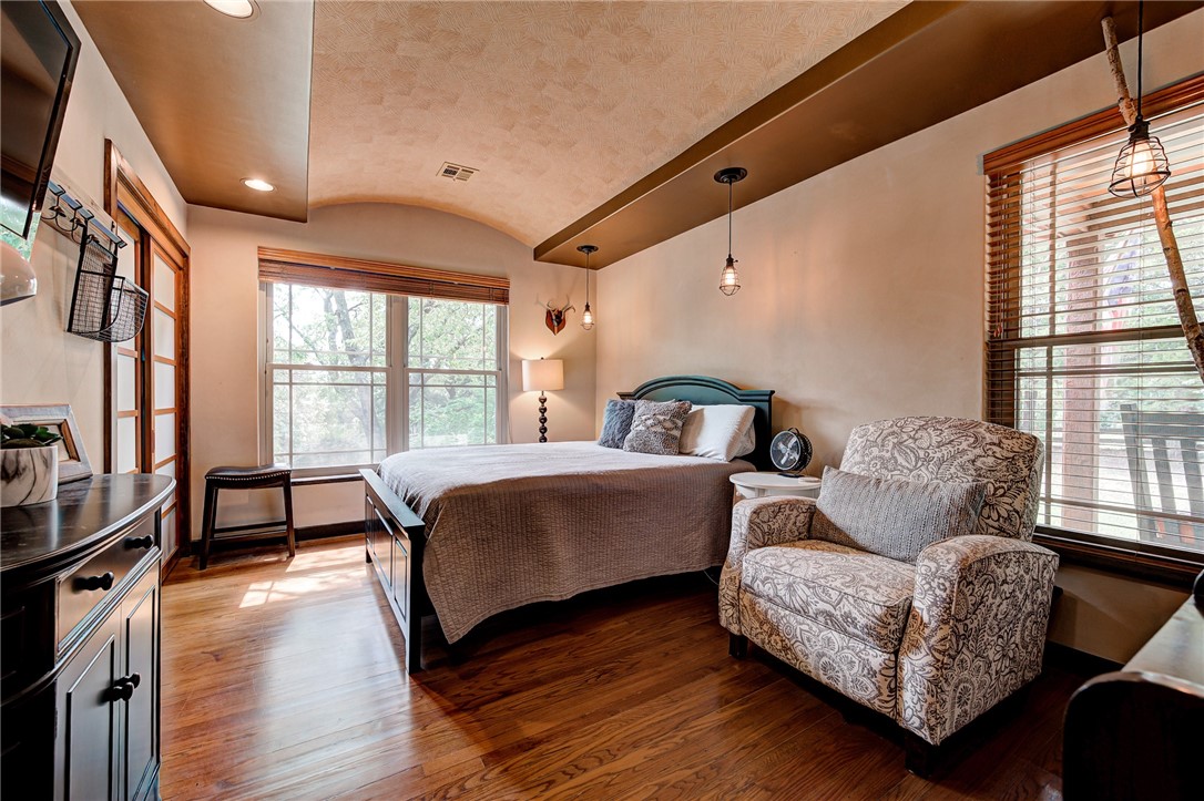 7900 N Bryant Avenue, Oklahoma City, OK 73131 bedroom featuring lofted ceiling and hardwood / wood-style flooring