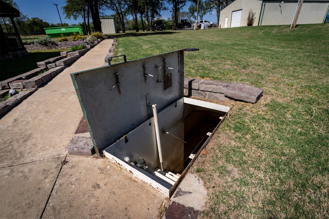 32101 W 256th, #S, Bristow, OK 74010 view of storm shelter with an outdoor structure and a lawn