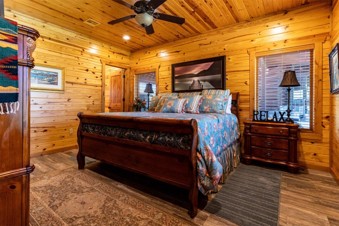 Address Hidden bedroom with wood-type flooring, ceiling fan, and wooden ceiling