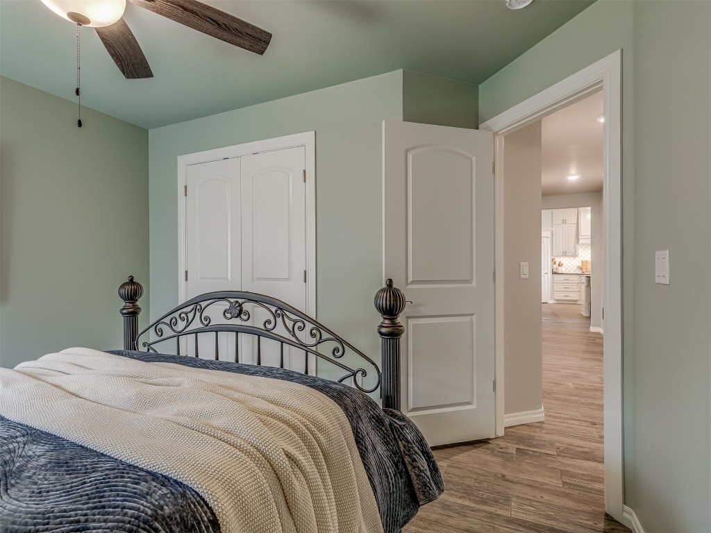 11812 Kylie Elizabeth Road, Yukon, OK 73099 bedroom featuring a closet, hardwood / wood-style floors, and ceiling fan