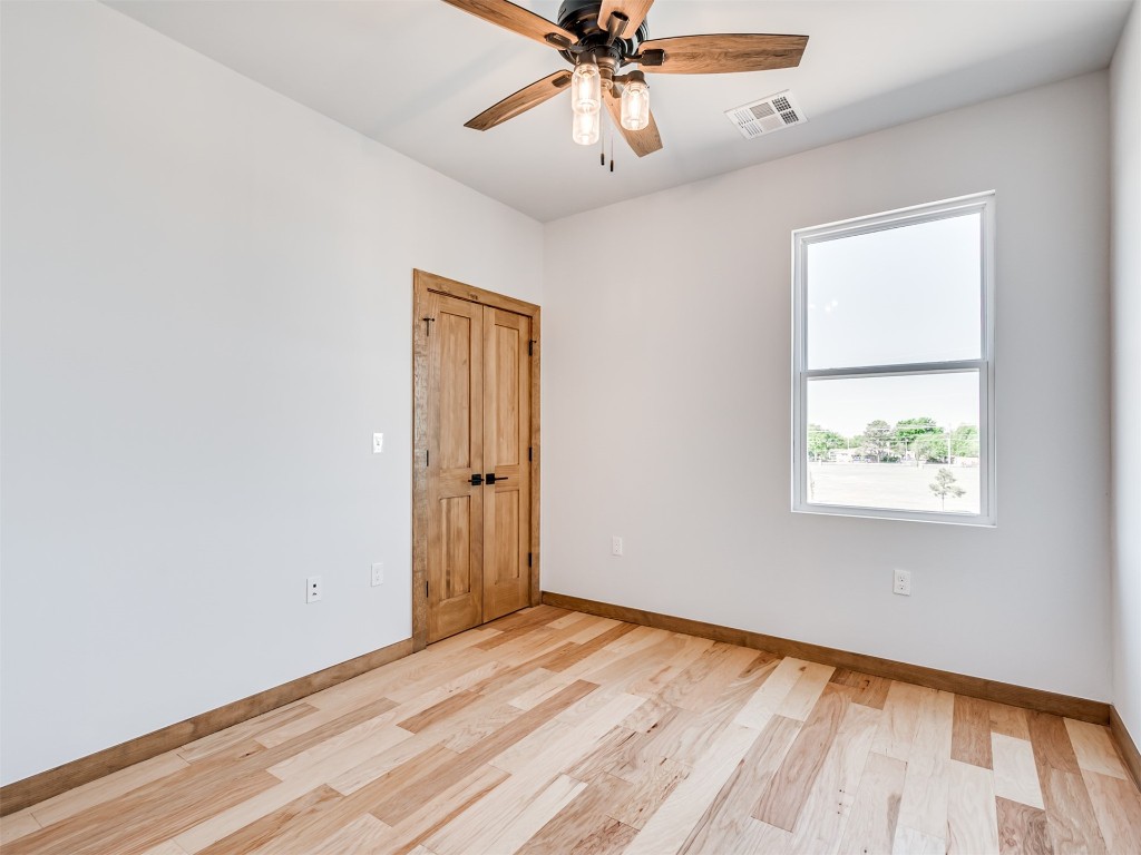 730 W Hurd Street, Edmond, OK 73003 unfurnished room featuring light hardwood / wood-style floors and ceiling fan