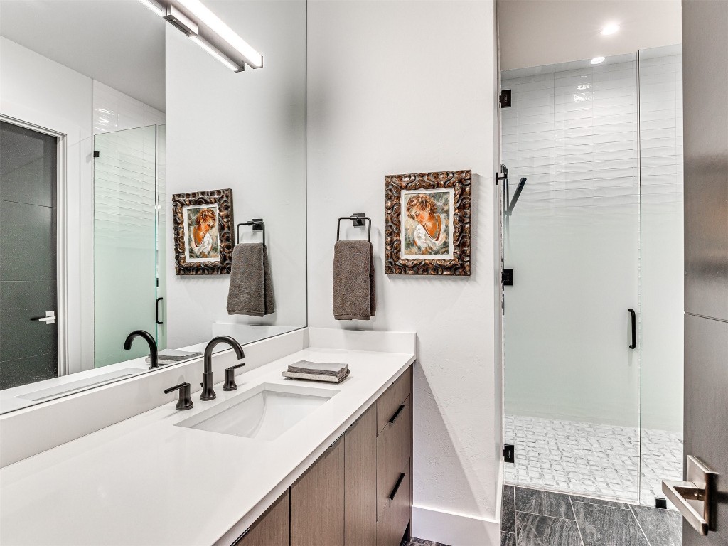 15613 Woodleaf Lane, Edmond, OK 73013 bathroom featuring walk in shower, oversized vanity, and tile floors