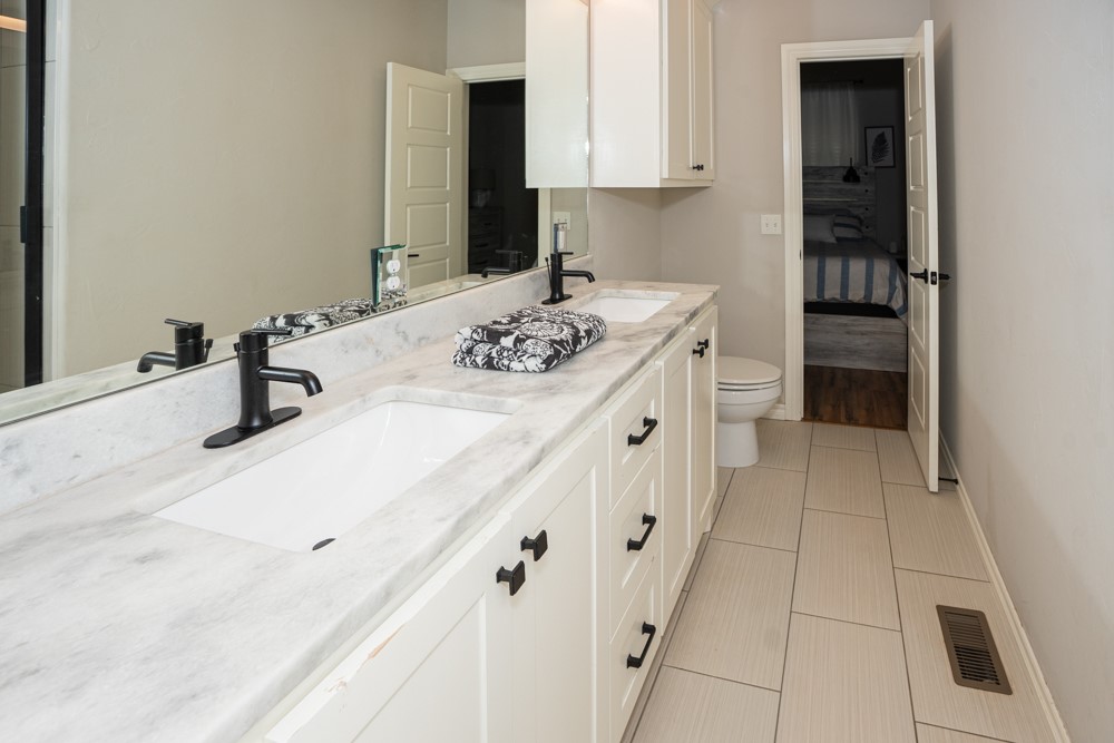 2508 Thornberry Lane, Yukon, OK 73099 bathroom featuring toilet, tile flooring, and double vanity