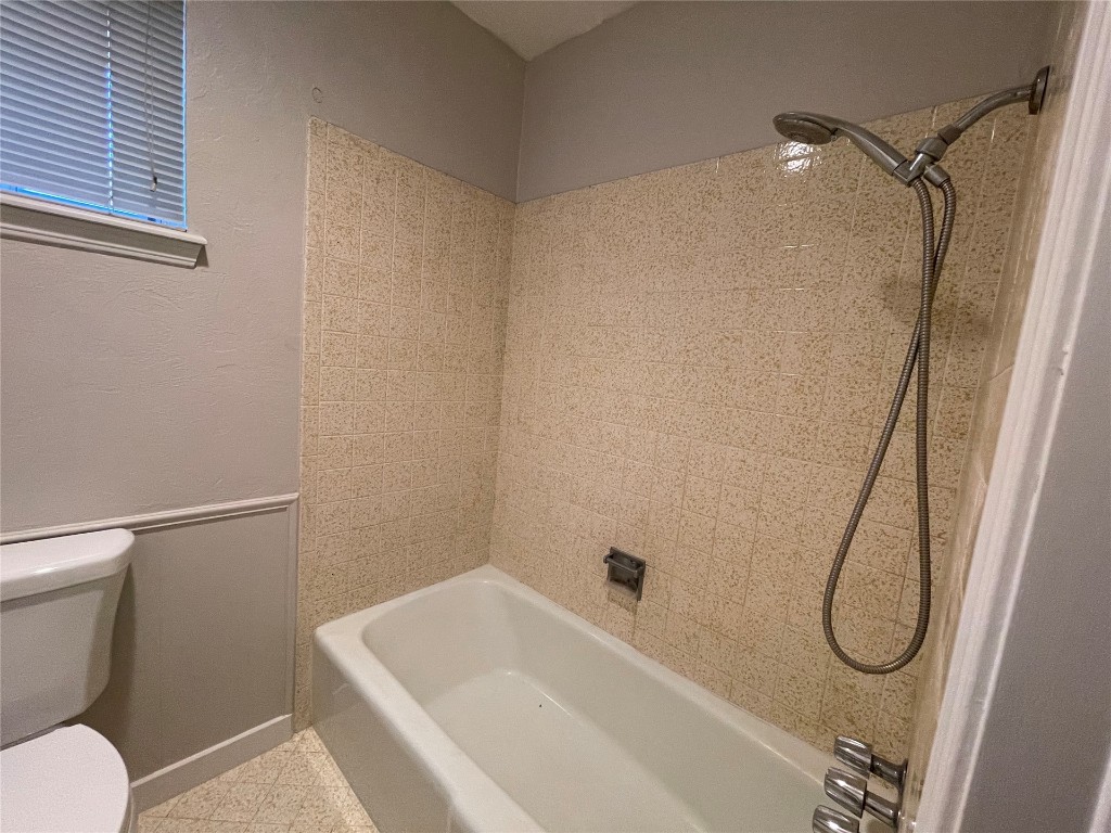 14217 Mount Vernon Place, Edmond, OK 73013 bathroom with tile floors, tiled shower / bath, and toilet