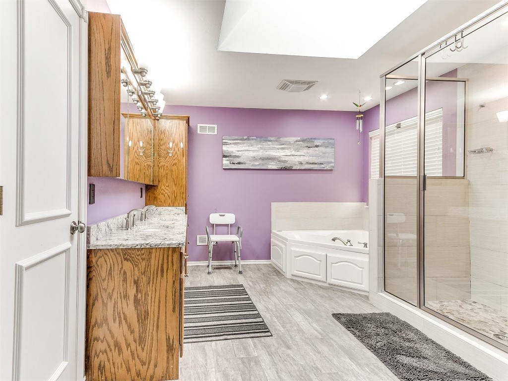 15512 Juniper Drive, Edmond, OK 73013 bathroom with vanity and shower with separate bathtub