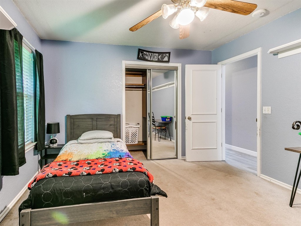 15512 Juniper Drive, Edmond, OK 73013 carpeted bedroom featuring a closet and ceiling fan