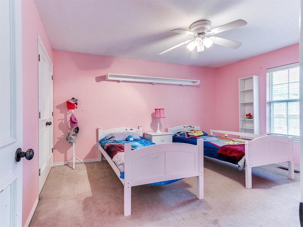15512 Juniper Drive, Edmond, OK 73013 carpeted bedroom featuring ceiling fan