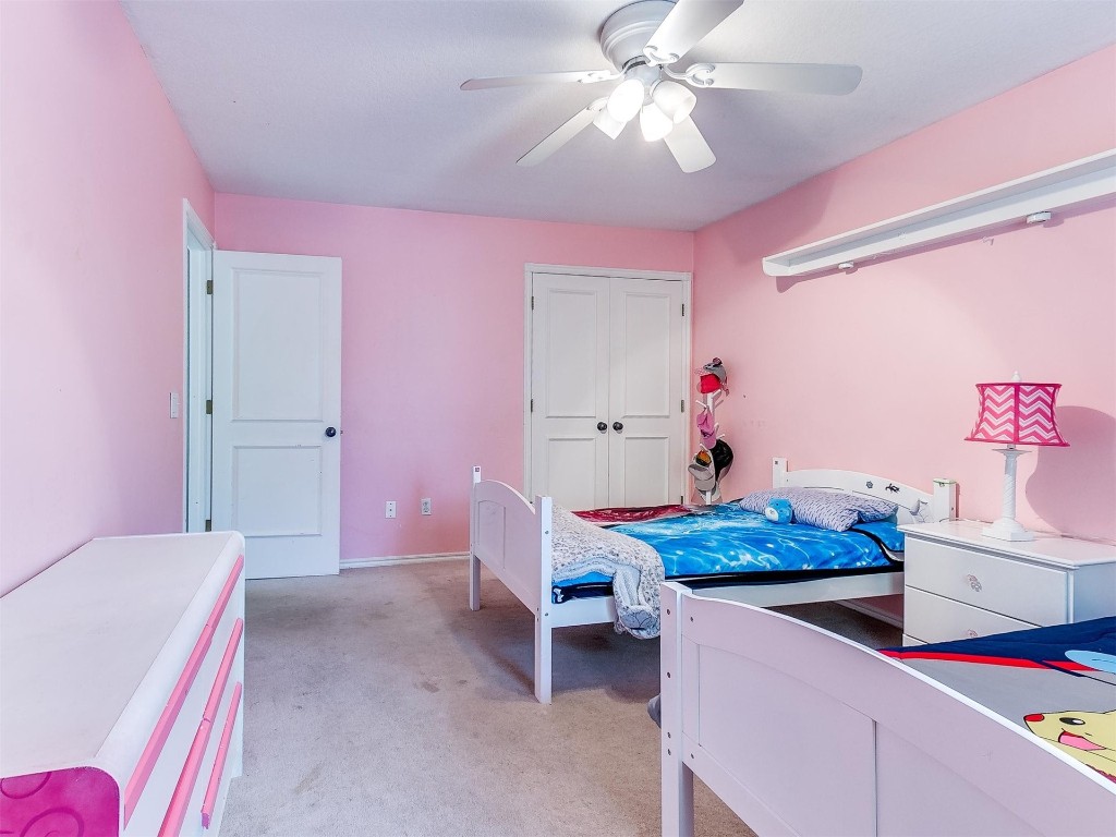 15512 Juniper Drive, Edmond, OK 73013 carpeted bedroom featuring a closet and ceiling fan