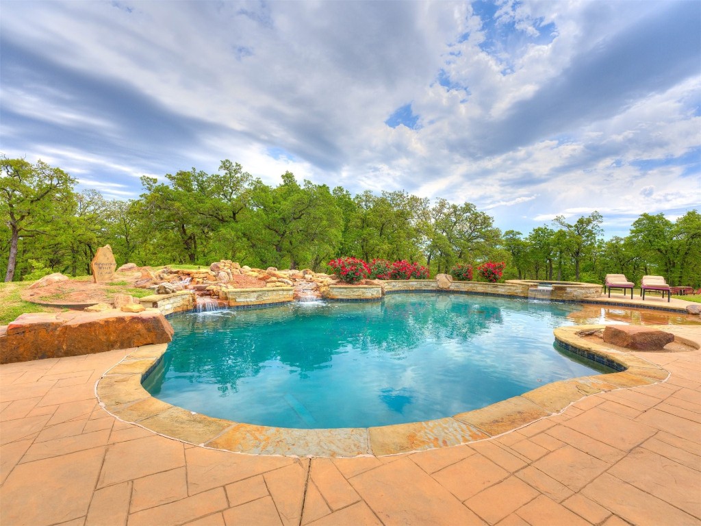 2050 S Henney Road, Guthrie, OK 73044 view of pool with a patio and pool water feature