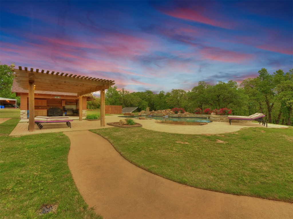 2050 S Henney Road, Guthrie, OK 73044 view of nearby features featuring a lawn, a pool, and a pergola