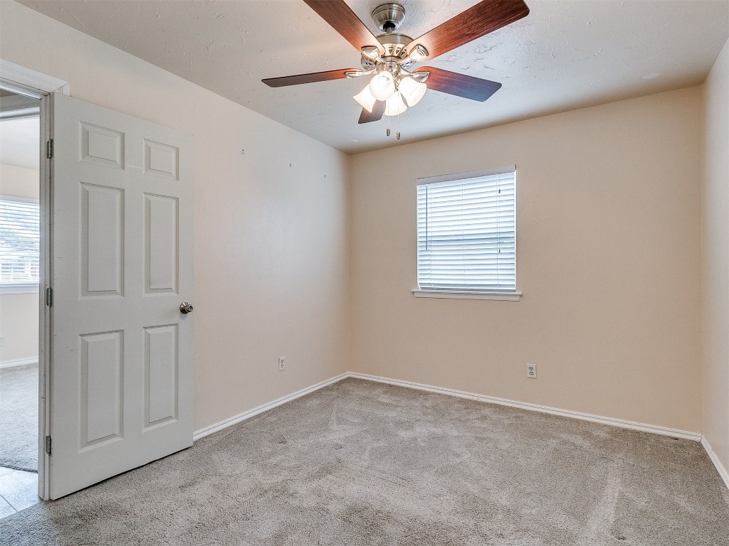 4708 Tate Drive, Del City, OK 73115 unfurnished room with plenty of natural light, carpet flooring, and ceiling fan