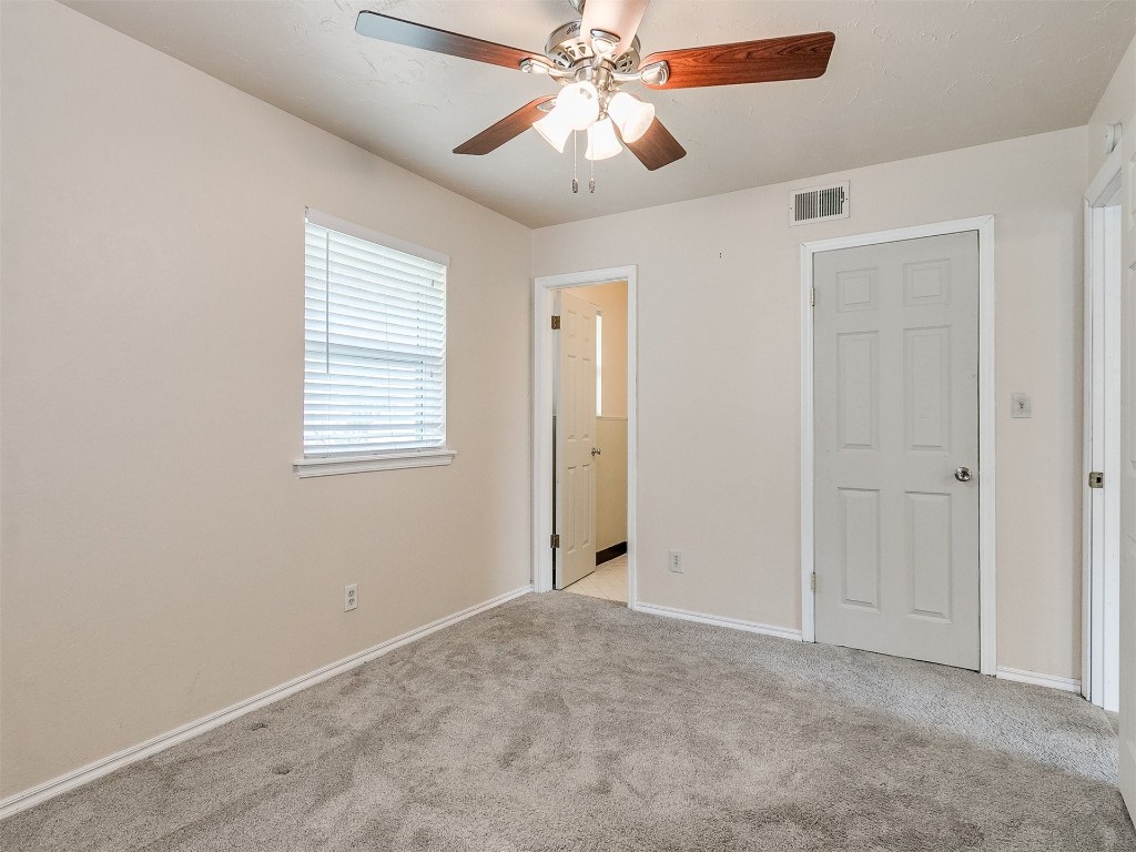 4708 Tate Drive, Del City, OK 73115 unfurnished bedroom featuring ceiling fan and light carpet