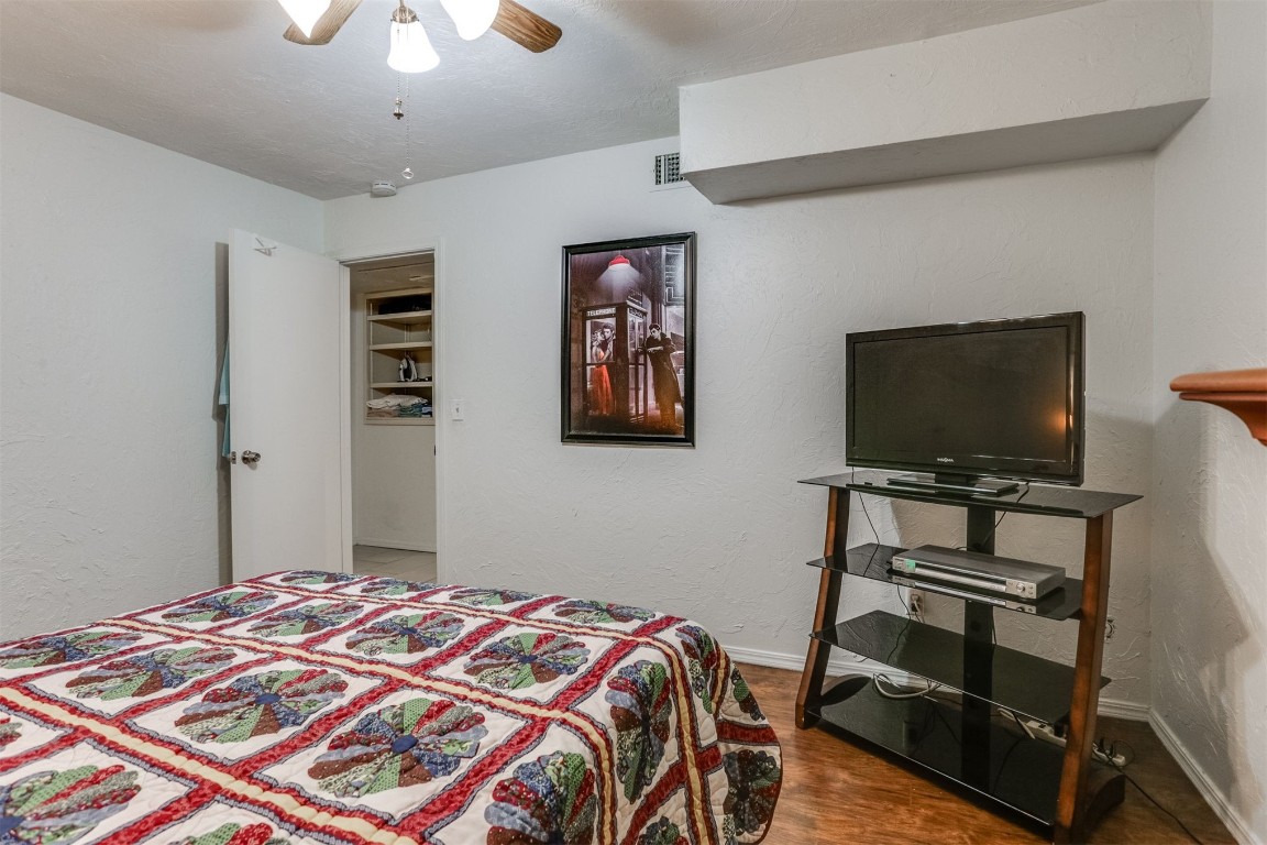 6732 N Meridian Avenue, #E, Oklahoma City, OK 73116 bedroom featuring ceiling fan and hardwood / wood-style flooring