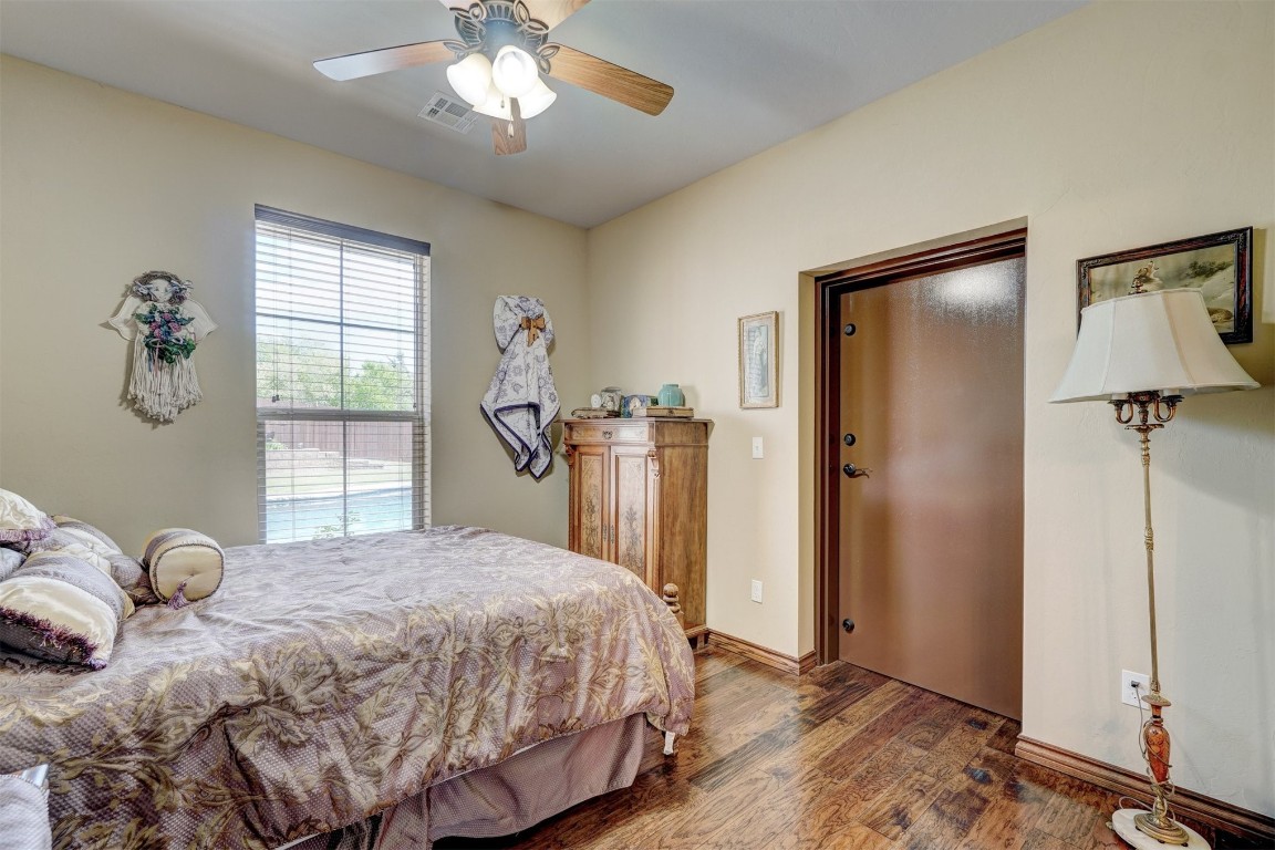 7829 E 2nd Street, Edmond, OK 73034 bedroom with ceiling fan and dark hardwood / wood-style floors