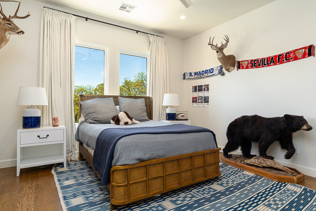 2525 Spring Lake Court, Jones, OK 73049 bedroom with dark hardwood / wood-style flooring