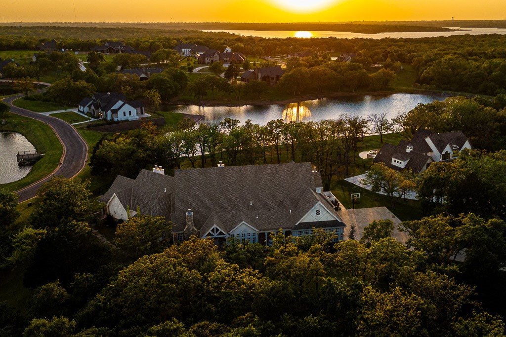 2525 Spring Lake Court, Jones, OK 73049 aerial view at dusk with a water view