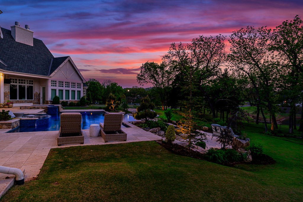 2525 Spring Lake Court, Jones, OK 73049 yard at dusk with a patio area and a swimming pool with hot tub