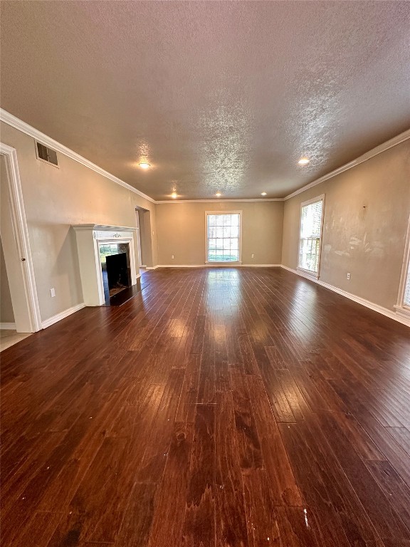 4311 N Georgia Avenue, Oklahoma City, OK 73118 unfurnished living room with dark hardwood / wood-style floors and ornamental molding