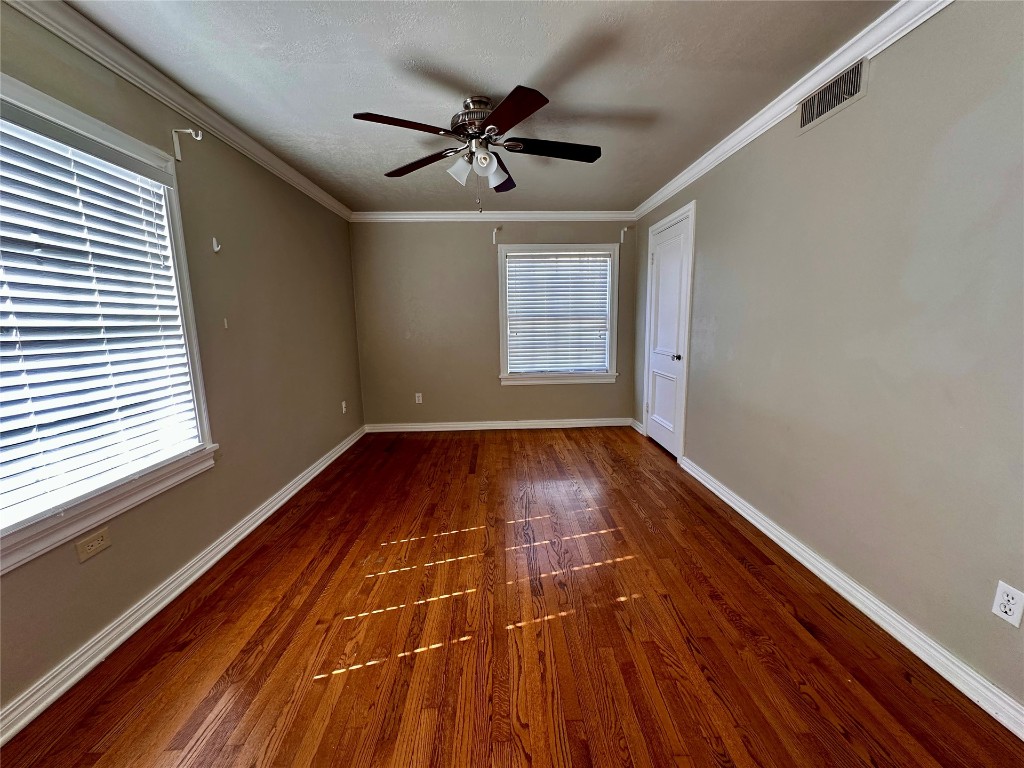 4311 N Georgia Avenue, Oklahoma City, OK 73118 empty room featuring ornamental molding, ceiling fan, and hardwood / wood-style flooring