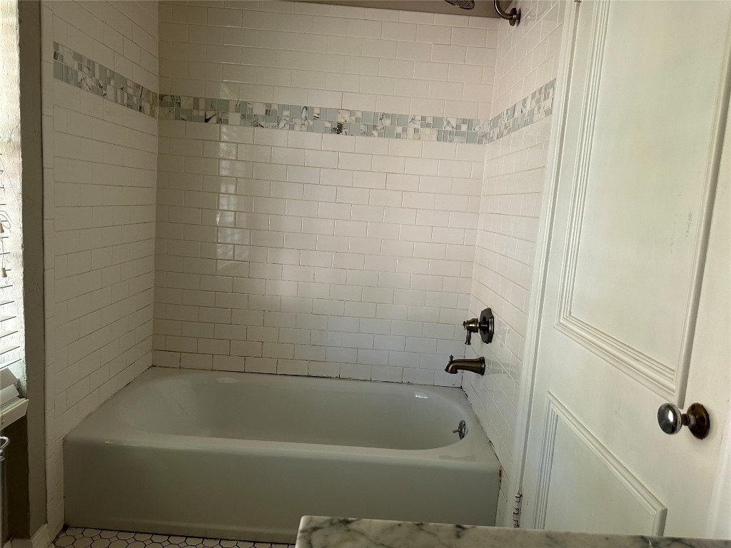4311 N Georgia Avenue, Oklahoma City, OK 73118 bathroom with tiled shower / bath combo and tile floors