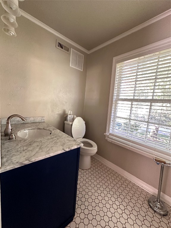 4311 N Georgia Avenue, Oklahoma City, OK 73118 bathroom featuring vanity, tile floors, toilet, and crown molding