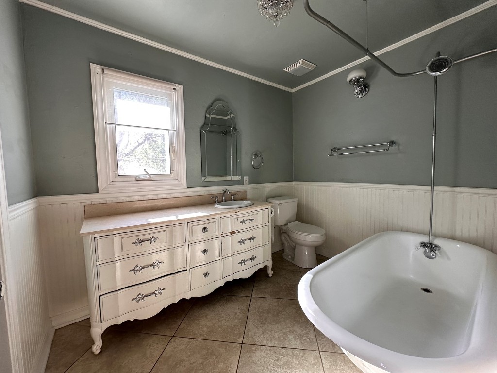 4311 N Georgia Avenue, Oklahoma City, OK 73118 bathroom featuring vanity, crown molding, toilet, and tile flooring