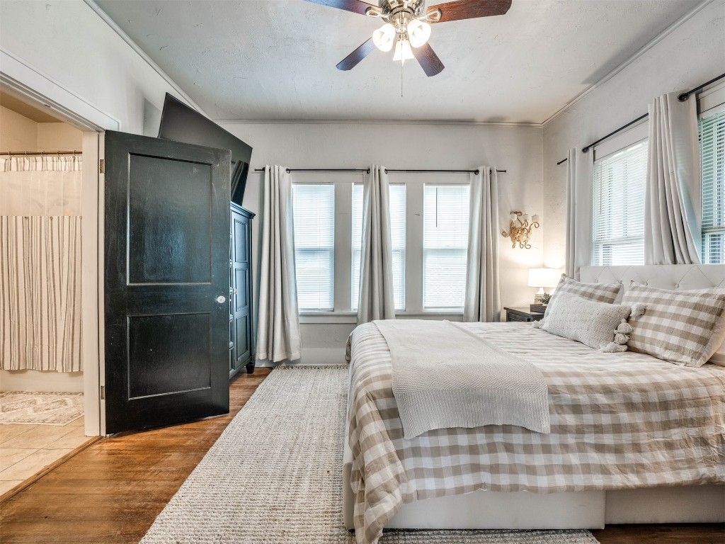 418 N Park Street, Guthrie, OK 73044 bedroom with hardwood / wood-style floors and ceiling fan