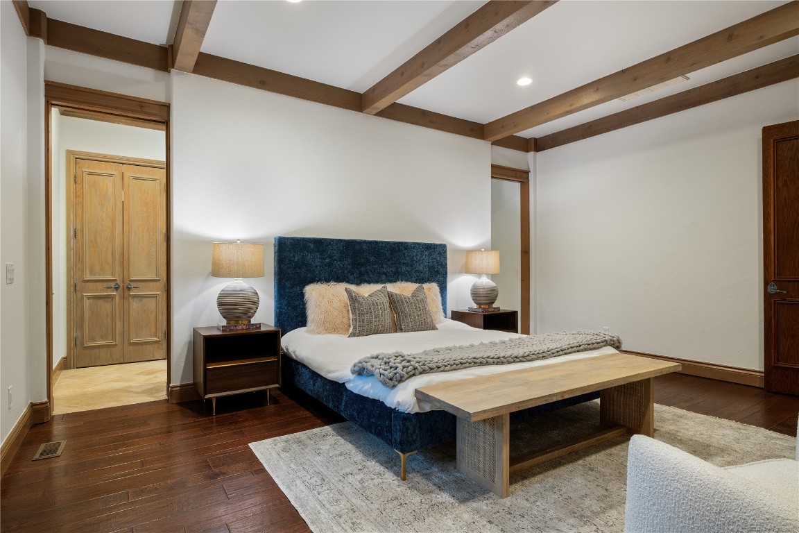18809 Wolf Creek Drive, Edmond, OK 73003 bedroom with hardwood / wood-style flooring and beam ceiling