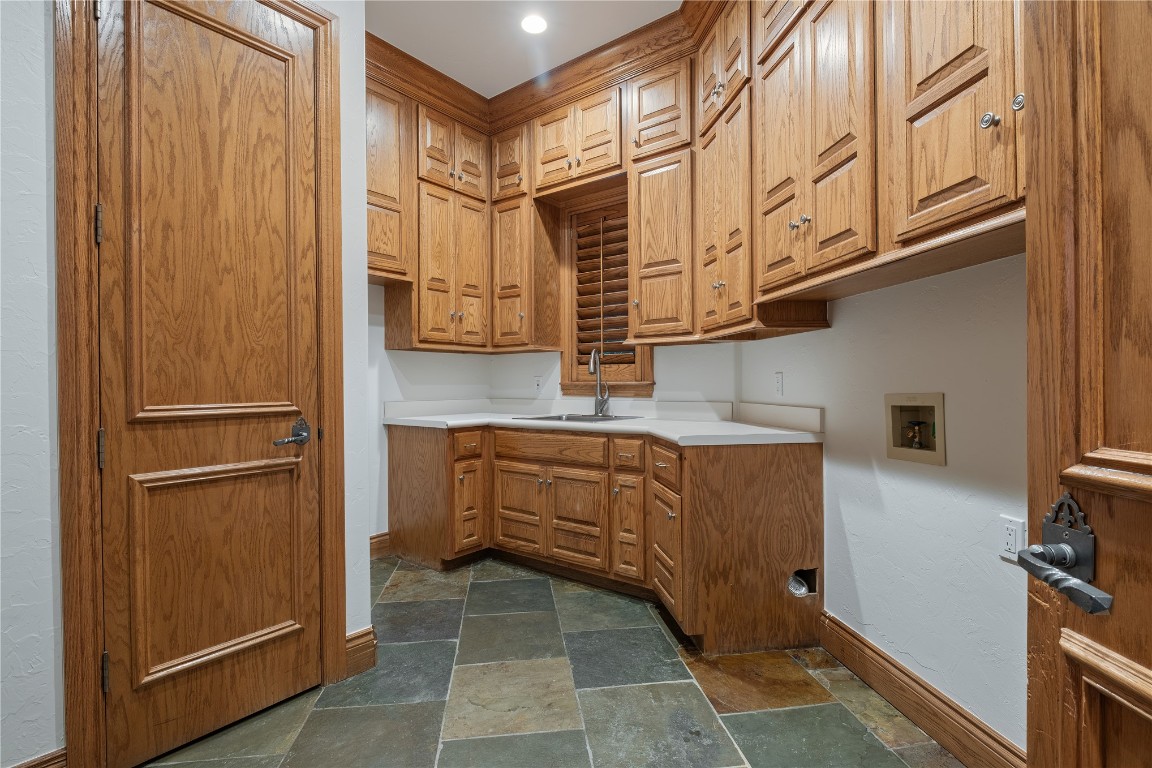 18809 Wolf Creek Drive, Edmond, OK 73003 kitchen with sink and dark tile flooring