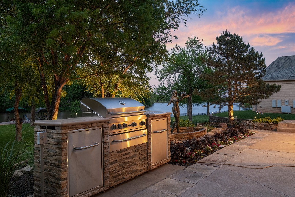 18809 Wolf Creek Drive, Edmond, OK 73003 patio terrace at dusk featuring area for grilling