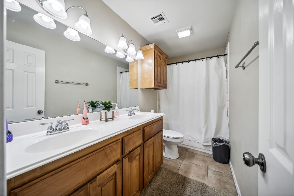 3193 S 206th  East Place, Broken Arrow, OK 74014 bathroom featuring double sink, toilet, tile flooring, and large vanity