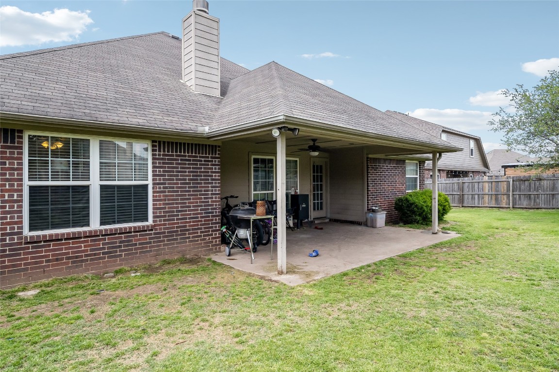 3193 S 206th  East Place, Broken Arrow, OK 74014 rear view of property with a patio area, a yard, and ceiling fan
