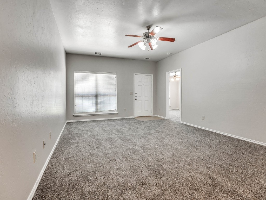 8613 SW 46th Place, Oklahoma City, OK 73179 unfurnished room with ceiling fan and carpet flooring