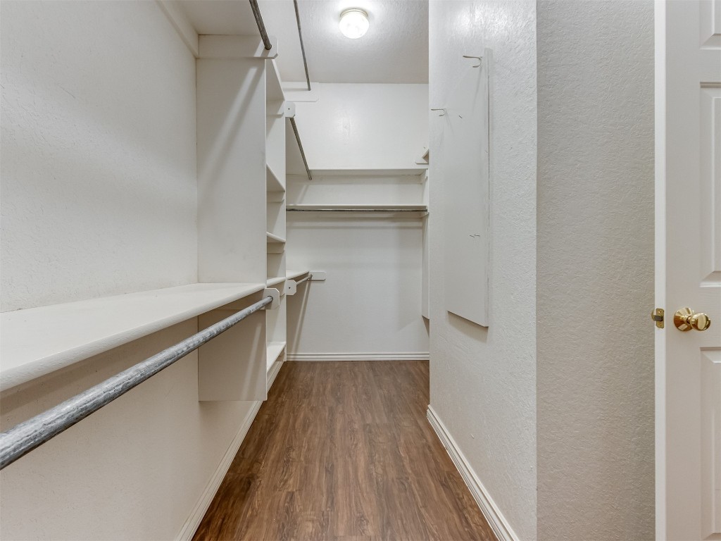 16605 Farmington Way, Edmond, OK 73012 spacious closet with dark wood-type flooring