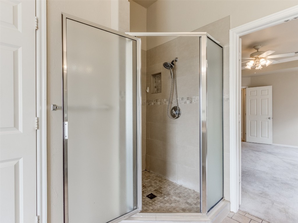 12109 Dalton Drive, Oklahoma City, OK 73162 bathroom with tile floors, ceiling fan, and a shower with door