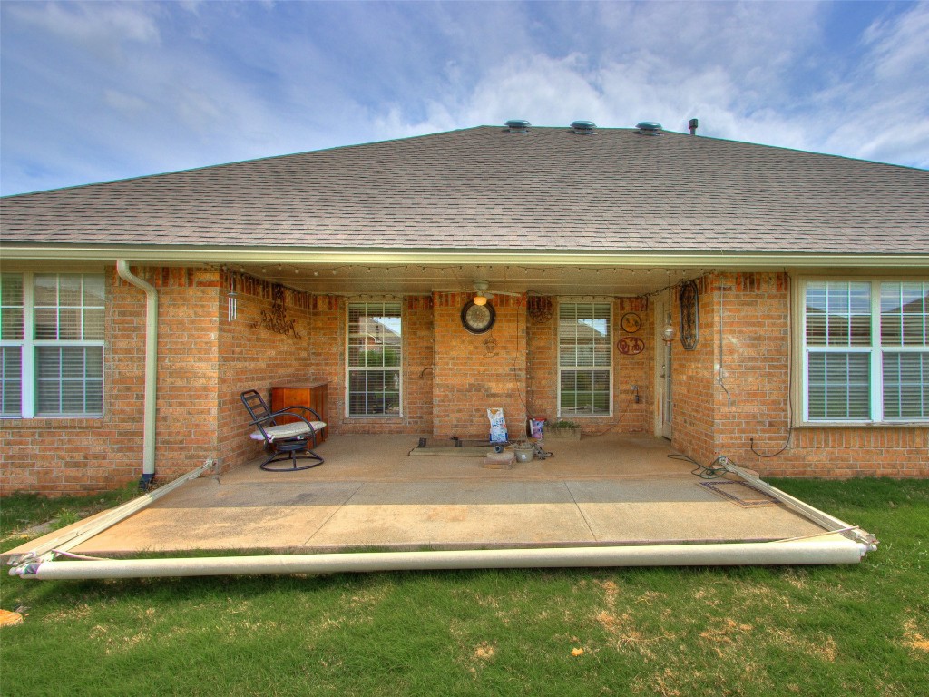12109 Dalton Drive, Oklahoma City, OK 73162 back of property featuring a patio area and a yard