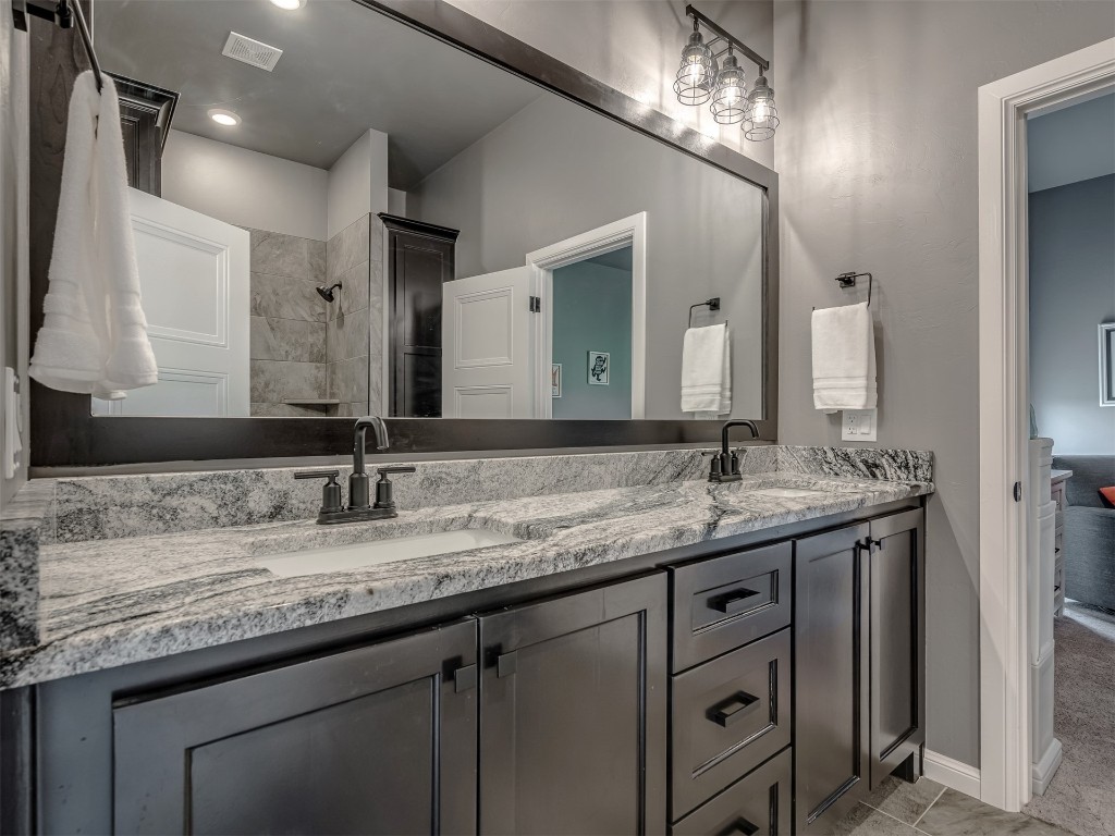 7300 Painted Sky Drive, Edmond, OK 73034 bathroom with tiled shower / bath combo, toilet, and tile flooring