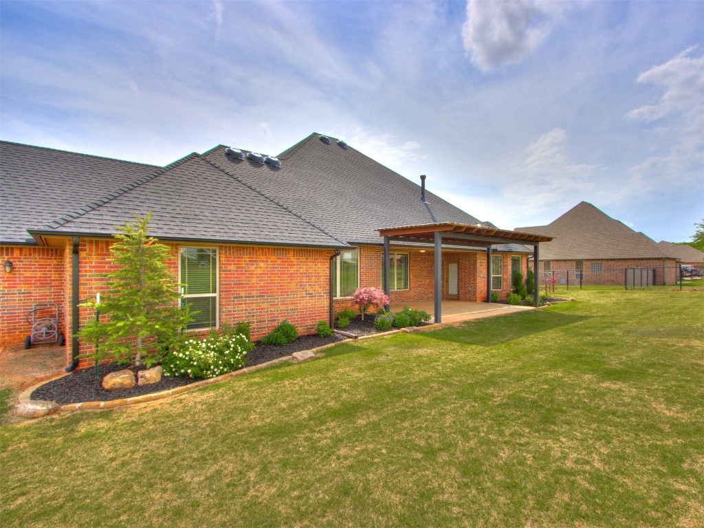 1015 Turkey Hollow Trail NE, Piedmont, OK 73078 rear view of property featuring a yard, a patio, and a pergola
